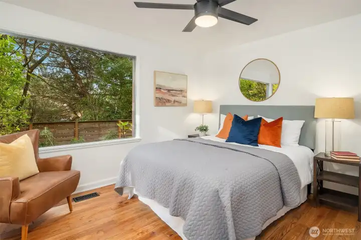 The primary bedroom has a large sunny windows.