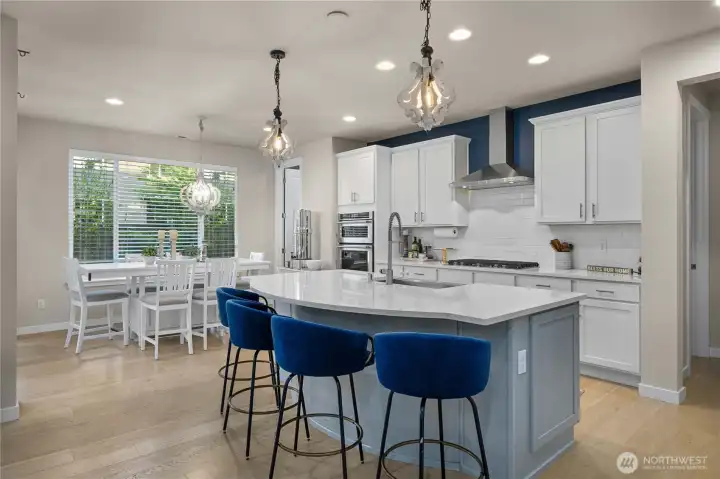 A casual dining space at one end opens out to the covered outdoor patio: just imagine having your morning coffee, an afternoon BBQ, or sipping a cool beverage on a hot summer’s day here!