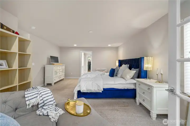 Upstairs, the expansive primary awaits, offering a large walk-in closet with organization and a lovely en suite bath with dual vanities, walk-in shower and soaking tub. Another bedroom connected through French doors could also be a nursery or large sitting room.