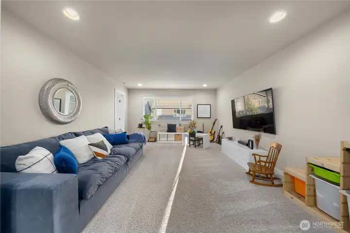 You’ll find two more bedrooms (total of 4 on this level), a full bath, laundry room, and an open loft area that could be another gathering space or media room.