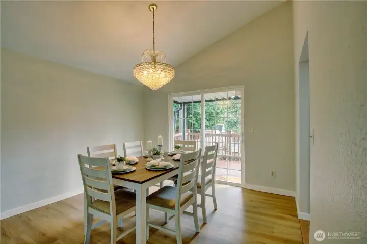 Large dining room with slider out to multi level deck.