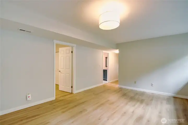 Rec-room facing bedroom #4, 1/2 bath laundry room and hallway to bonus room and garage door