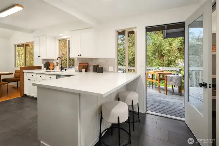 The kitchen opens up to a deck that extends the length of the home for morning coffee & evening night caps.
