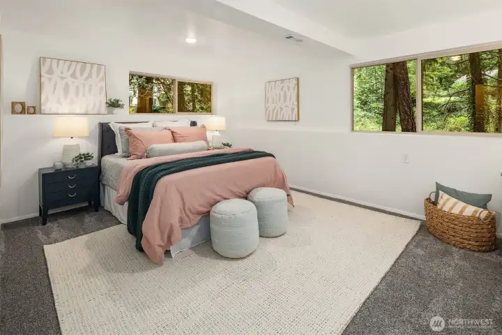 Downstairs bedroom (non-conforming) with huge windows with pretty peeks of green!