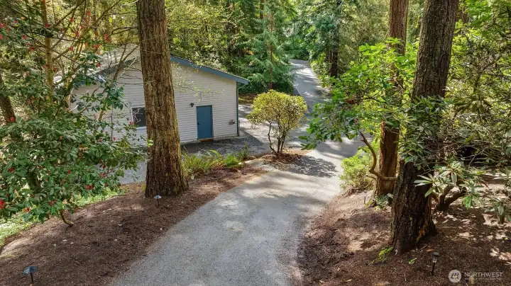The meandering driveway is enchanting, providing privacy & ample parking in multiple locations. RV, boat, multiple cars, no problem!