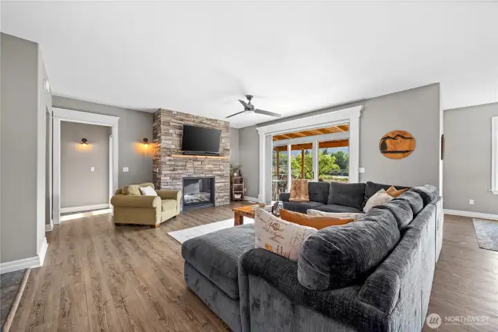 Stone surround propane fireplace anchors the living room
