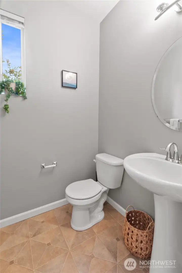 Main floor powder room next to living room. Main floor powder room next to living room.