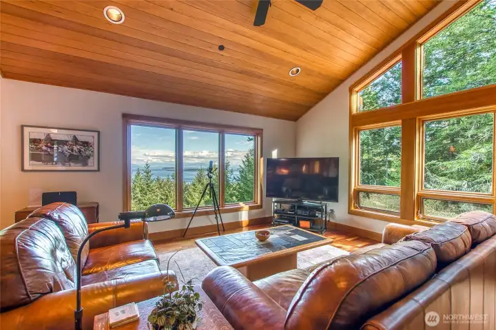 The comfortable light-filled great room with south wall of window to capture forest views and a bank of east windows for marine views The comfortable light-filled great room with south wall of window to capture forest views and a bank of east windows for marine views