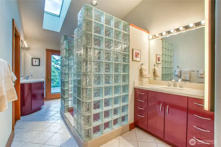 Main floor primary suite bath has skylights, dual vanities, walk-in shower, bidet, large linen closet & laundry center Main floor primary suite bath has skylights, dual vanities, walk-in shower, bidet, large linen closet & laundry center