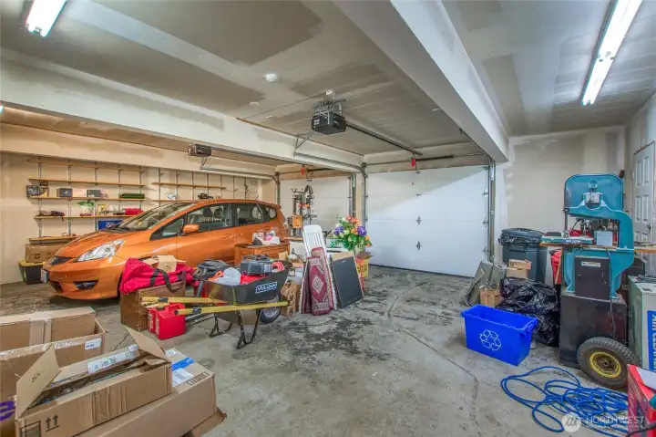 Oversized (nearly 700 sq.ft.) garage with 2 overhead doors. There's a heater that's unplugged; current owners have never tried to use it. A 220v outlet was wired for EV charger to connect Oversized (nearly 700 sq.ft.) garage with 2 overhead doors. There's a heater that's unplugged; current owners have never tried to use it. A 220v outlet was wired for EV charger to connect