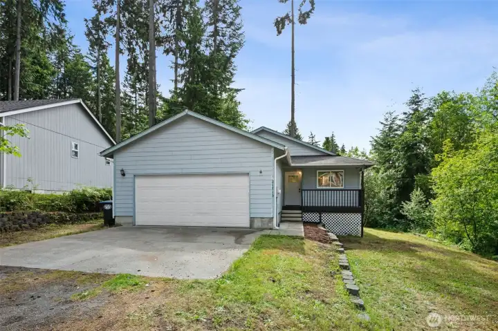 front of the house with rv parking on the left side