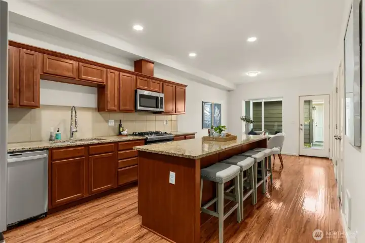 Kitchen with breakfast bar seating, granite counters & stainless appliances Kitchen with breakfast bar seating, granite counters & stainless appliances