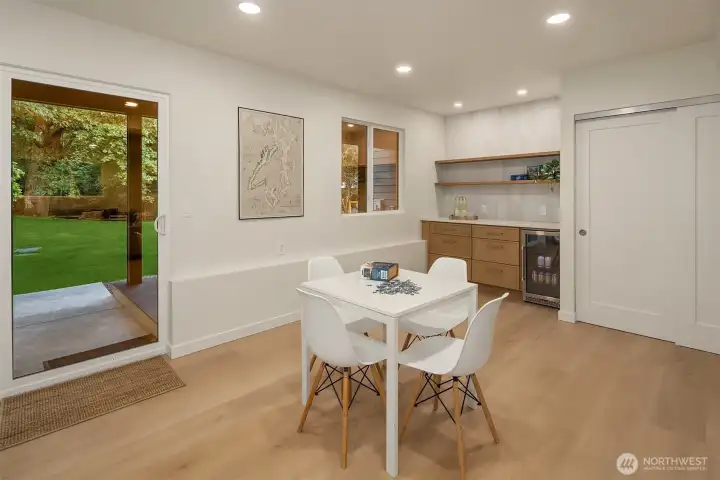 Bonus room features custom cabinetry with quartz counter tops, open faced shelving and a beverage refrigerator