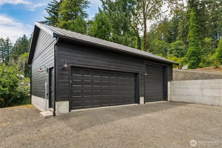 Brand new 768 sq. ft garage with 3 stalls.  The RV stall has a 14 ft garage door.  New retaining wall installed