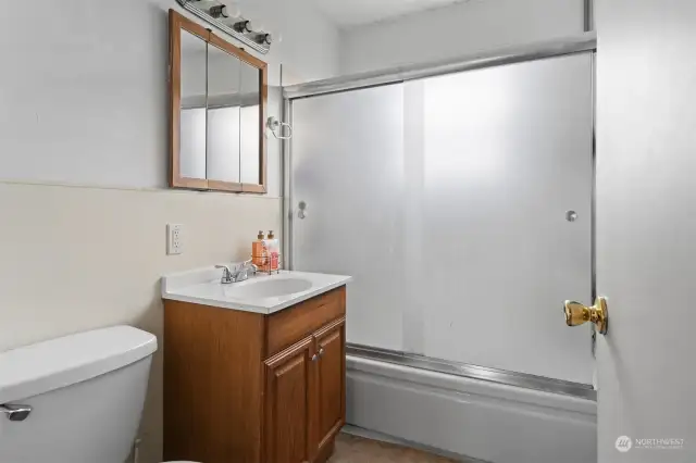 Full bathroom with shower/tub combo.