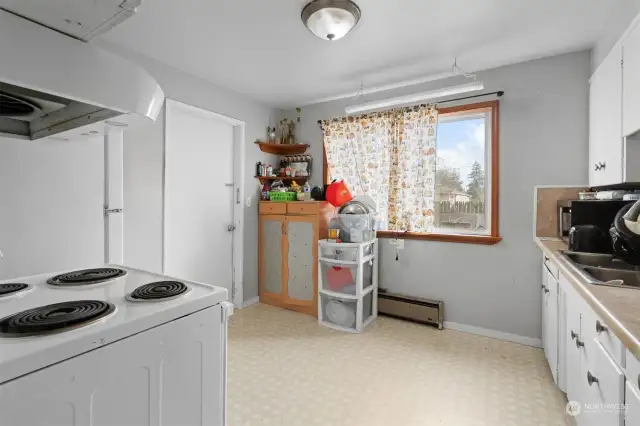 Cozy white Kitchen with views of the back yard.