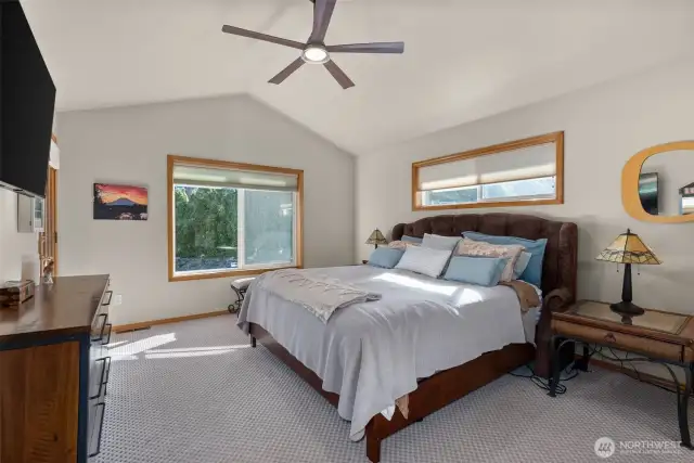 The primary bedroom boasts its own entry to the deck and dual closets.