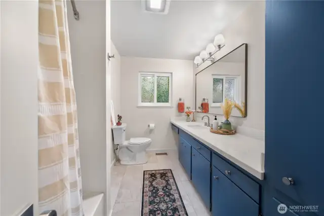 Updated main bathroom with large vanity and new quartz countertops.
