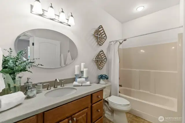 A shared full bathroom is located conveniently in the hall between the bedrooms.