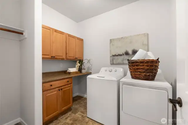 Conveniently located between the bedrooms, the laundry facility is functional with counter and cabinet space and a place to hang your freshly laundered clothing. The washer and dryer convey with the home.