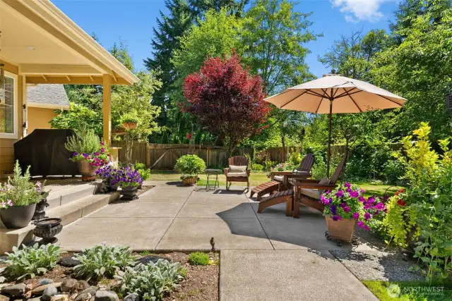 Imagine savoring Pacific Northwest summers in this beautiful backyard, featuring a covered porch perfect for barbecuing and plenty of space to run, play, and relax.