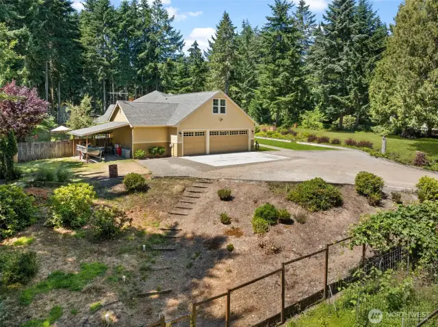 A fenced garden enclosure provides the perfect space to cultivate your own vegetables, plants, or favorite flowers. A huge parking area can accommodate multiple vehicles with ease while a covered attached car port can provide additional storage.