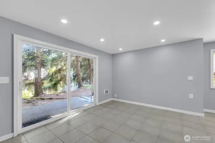 Spacious living room with sliding glass door to private patio in Bothell townhome.