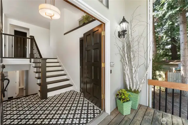 From the front porch looking in, the recently tiled floors are a tasteful change from what you normaly see in most homes, and the stairs and spindles have been updated to showcase the stairs.