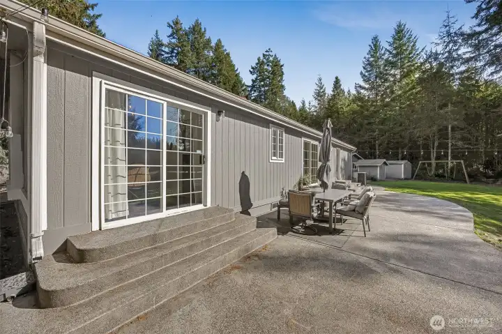 Sliding doors off dining room and kitchen for easy indoor and outdoor access.