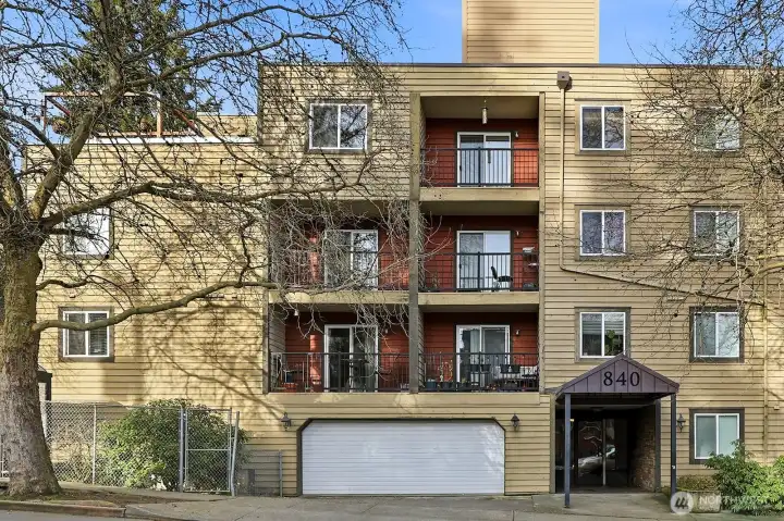 Front of building with garage access and lobby entrance.