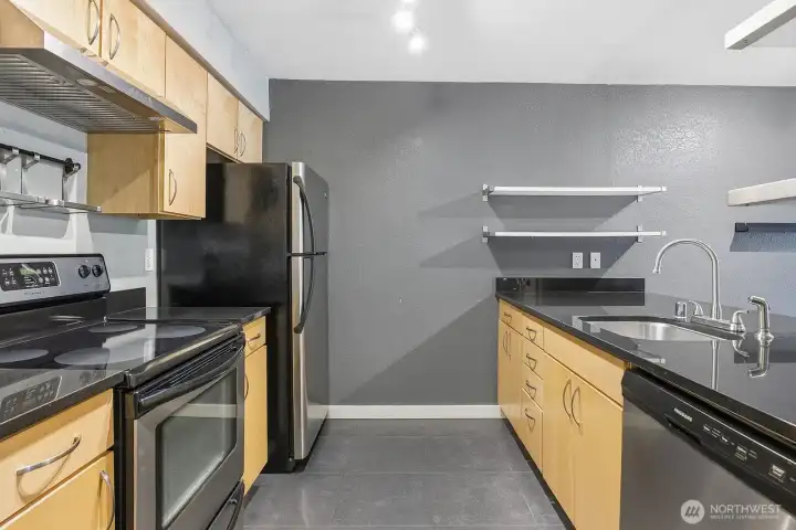 Kitchen with updated stainless appliances.