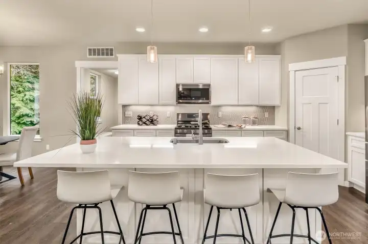 Open plan chef’s kitchen with bar seating makes this kitchen the place to be