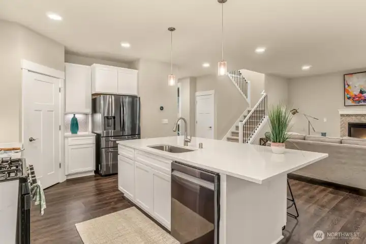 Stunning kitchen has recessed lighting to and beautiful surfaces throughout
