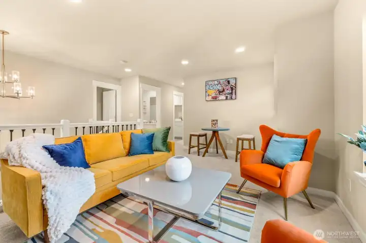 Loft rec room has abundant natural light and space for fun. Recessed lighting and big windows.