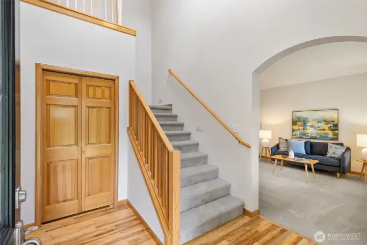 The entryway welcomes you with stairs leading to the second level and the living room just off to the right.