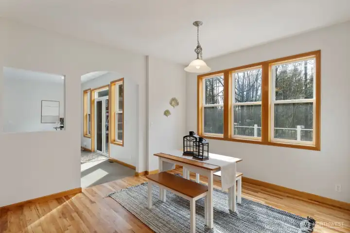 Casual dining area adjacent to the kitchen, featuring views of the backyard and deck.