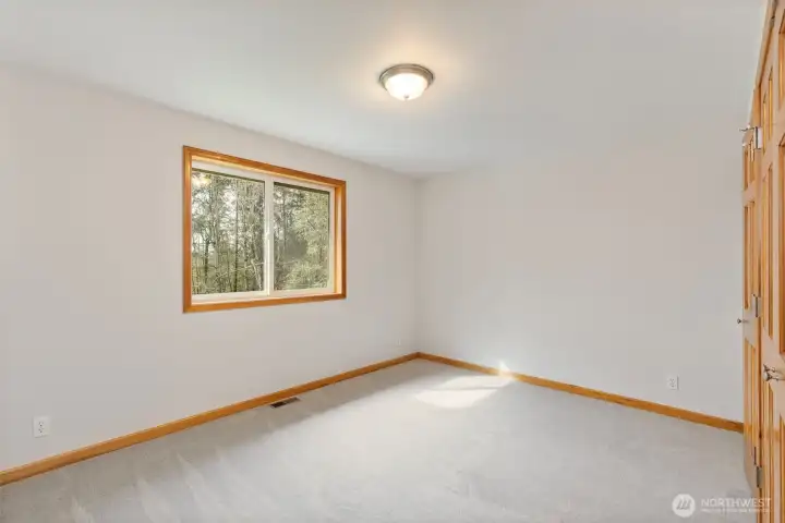 Large bedroom at the top of the stairs, perfect for a bedroom, office, or bonus space.