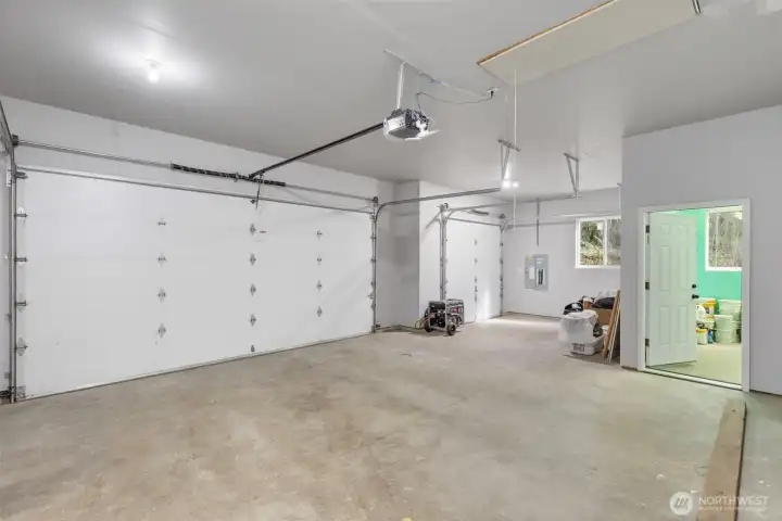 Spacious 772 sq. ft. attached three-vehicle garage with an integrated workshop.