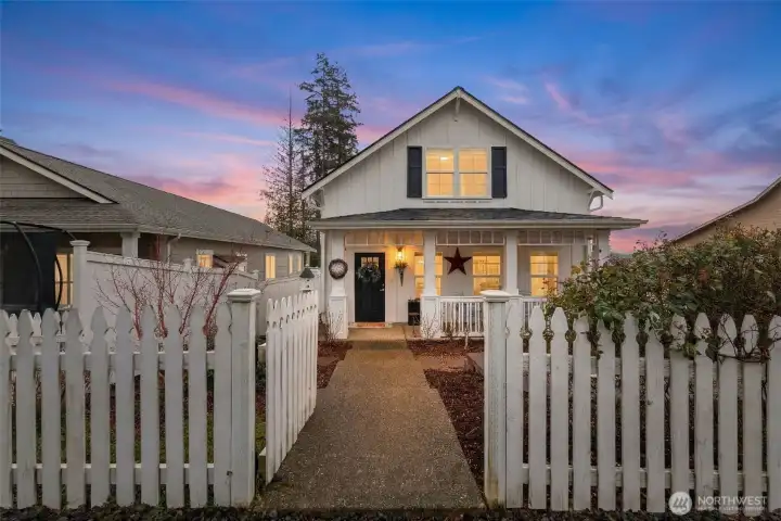 Storybook curb appeal with classic white picket fence.