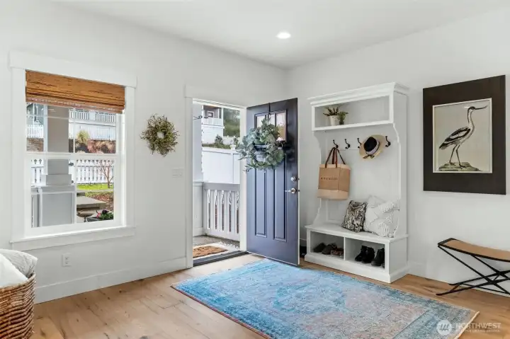Welcoming entry with built-in storage and wide-plank hardwood floors