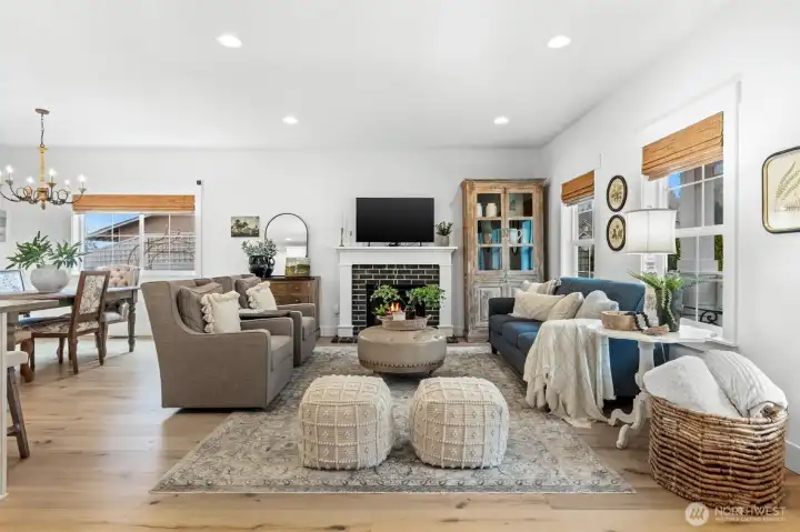 Spacious living room anchored by cozy fireplace