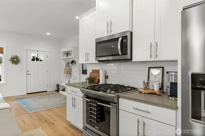 White cabinetry, stainless appliances, and thoughtful finishes
