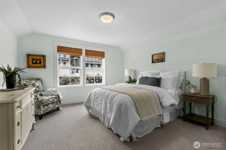 Comfortable guest bedroom with soft natural light