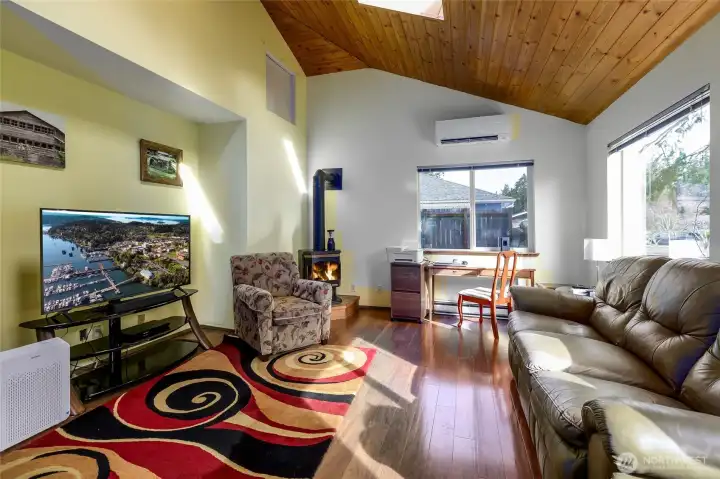 Cozy gathering space with large windows and an inviting atmosphere.