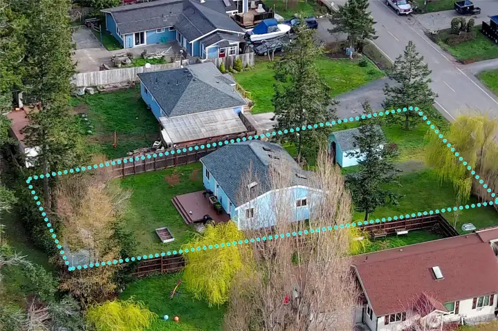 Detailed aerial perspective showcasing the home and the full extent of the lot.