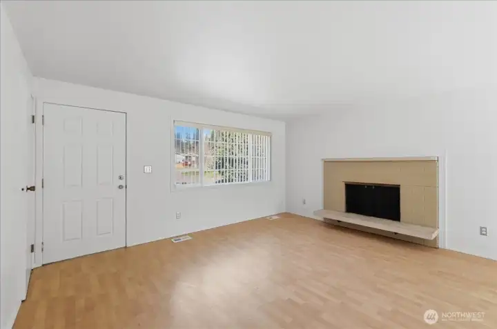Living room with wood burning fireplace.