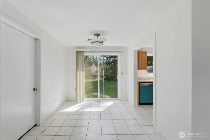 Dining area with access to the backyard and attached one car garage with bonus room.