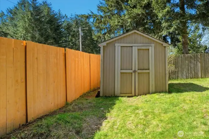 Shed (could use some work) with new fencing and RV parking gate on the left.