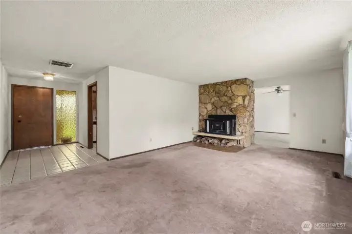 As you enter, the kitchen is off to the left and this living room is straight ahead.