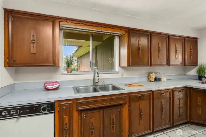 Window over the sink looks out toward the front of the home.